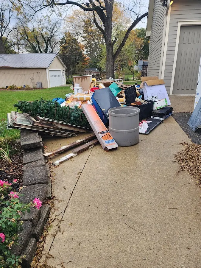 Dumpster being loaded with debris for Residential Dumpster Rental in Milton
